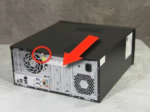  Image of a computer on its side with a side panel retaining screw called out and a directional arrow pointing to the rear of the computer.
